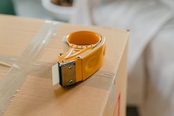 A tape dispenser on a moving box