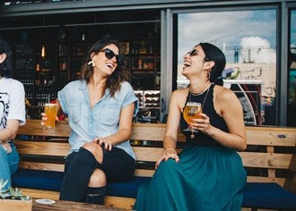 Two women talking and laughing together.