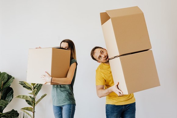 Couple carrying boxes