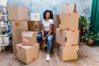 A girl surrounded by packing boxes