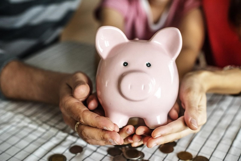 A couple holding a piggy bank